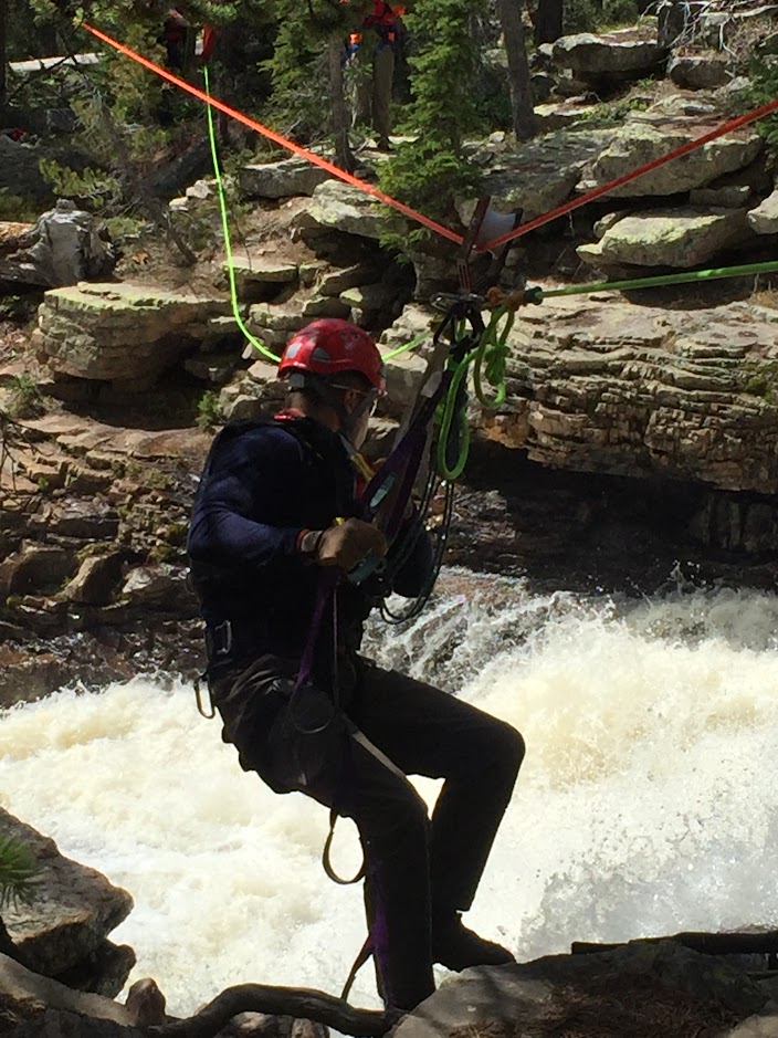 Technical rope rescue highline operation over waterfall